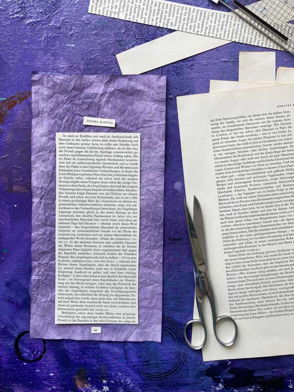 Collagesituation. Seiten aus dem Buch wurden ausgeschnitten und liegen auf dem Tisch, eine Schere, Schnipsel.